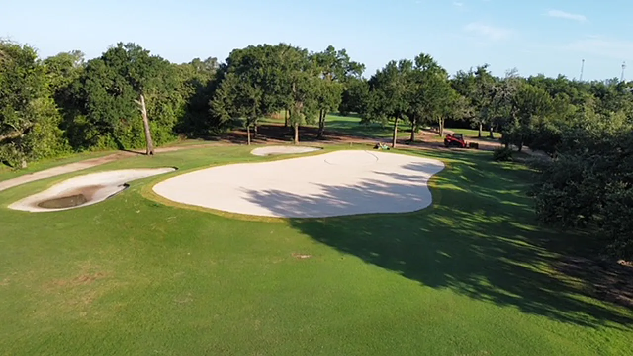A sand bunker under construction at a golf course.